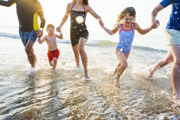 family splashing in port aransas beach