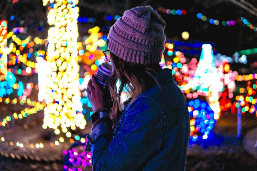 woman looking at holiday lights in the park