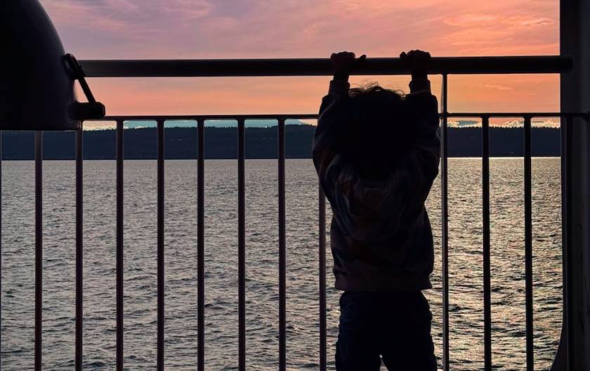 Toddler on ferry ride looking at the water